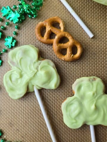 Gluten free shamrock pretzel pops dipped in chocolate on lollipop sticks for St. Patrick’s Day