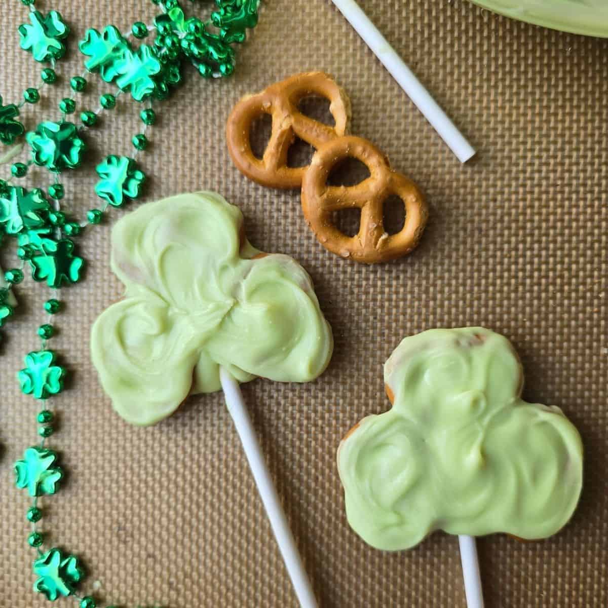 Gluten free shamrock pretzel pops dipped in chocolate on lollipop sticks for St. Patrick’s Day