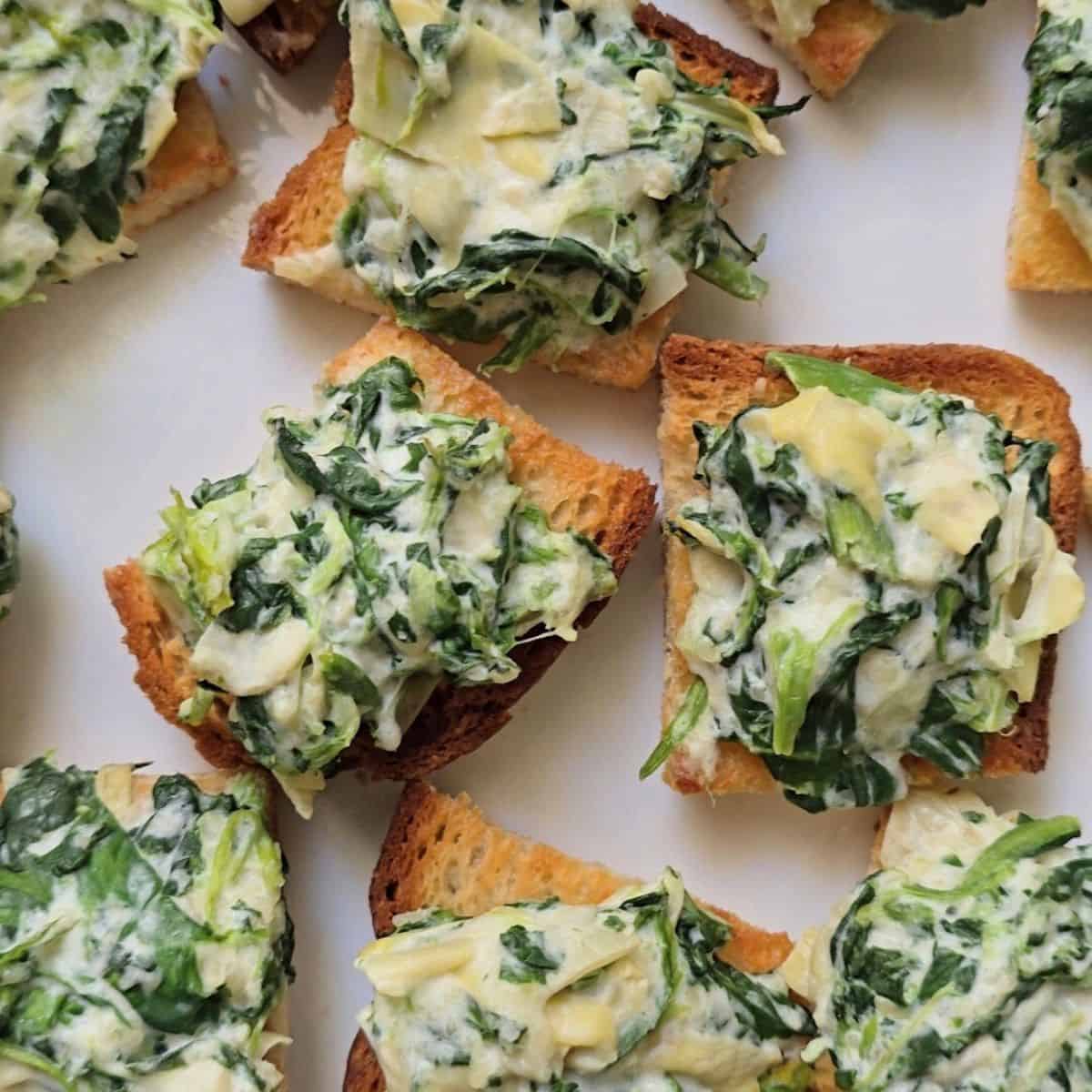 Gluten free spinach artichoke crostini on toasted sourdough bread