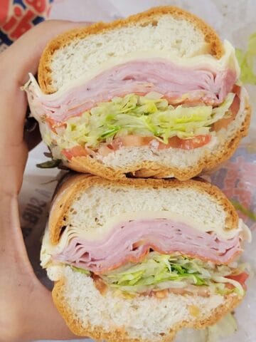 Gluten free Jersey Mike's sub sandwich with ham, cheese, lettuce and tomato