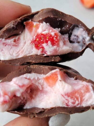 Frozen strawberry yogurt clusters with creamy yogurt and chocolate coating.