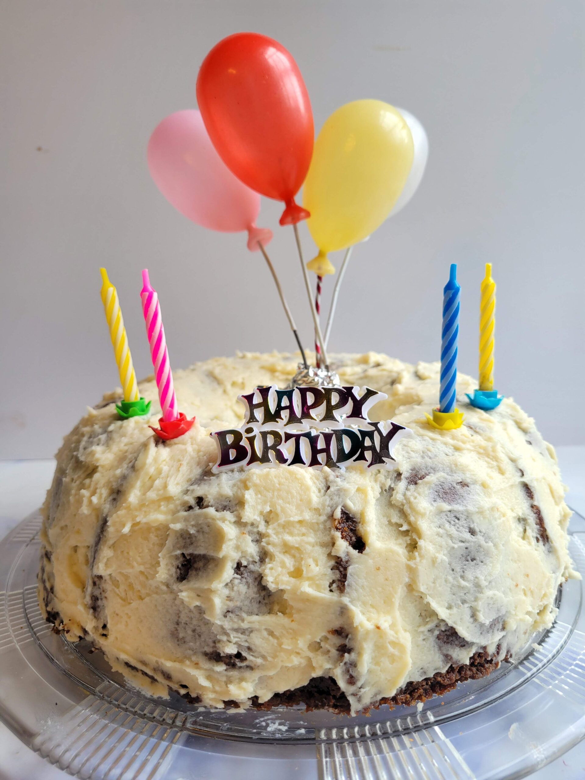 Homemade gluten free chocolate cake decorated with frosting for a birthday celebration