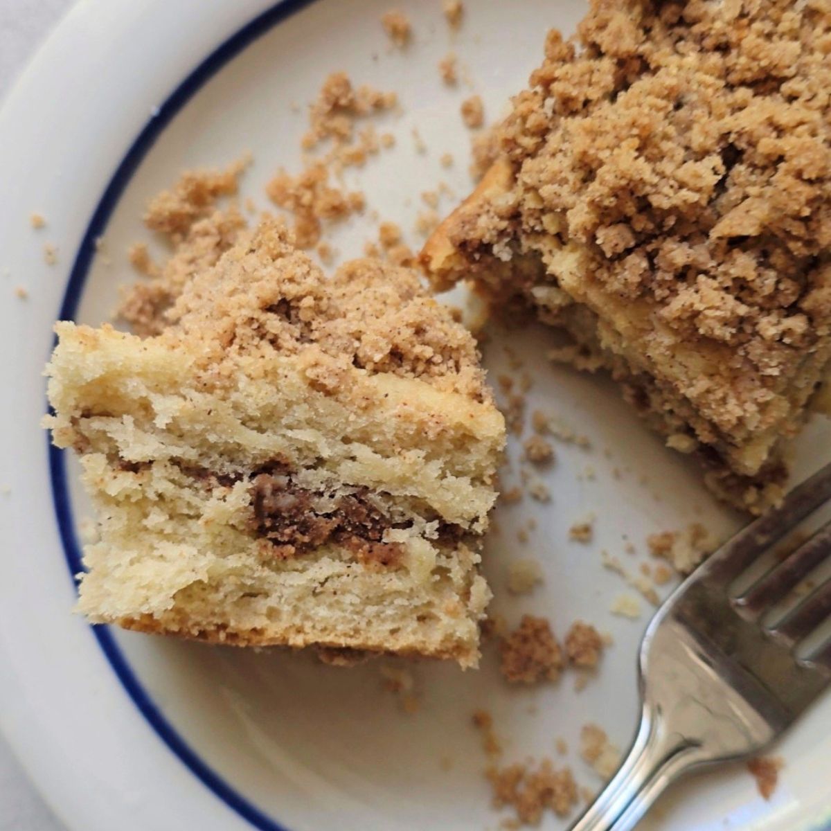 Slice of gluten free cinnamon swirl coffee cake showing soft fluffy texture and cinnamon layers