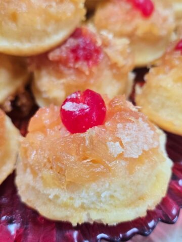 Gluten free pineapple upside down cupcakes served on a dessert plate