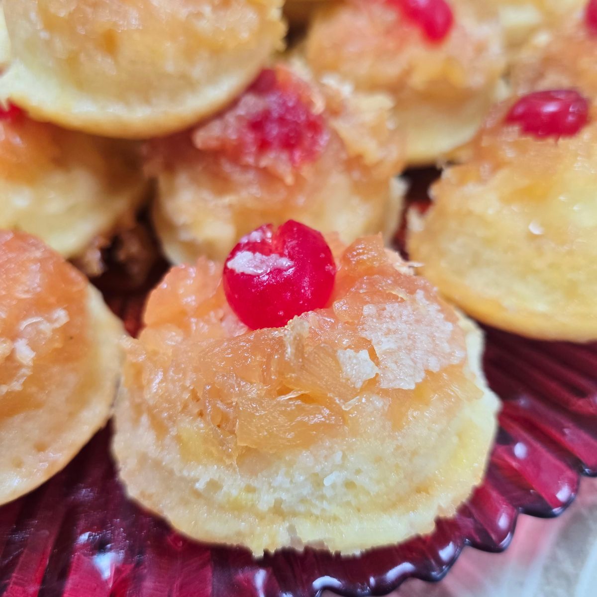Gluten free pineapple upside down cupcakes served on a dessert plate