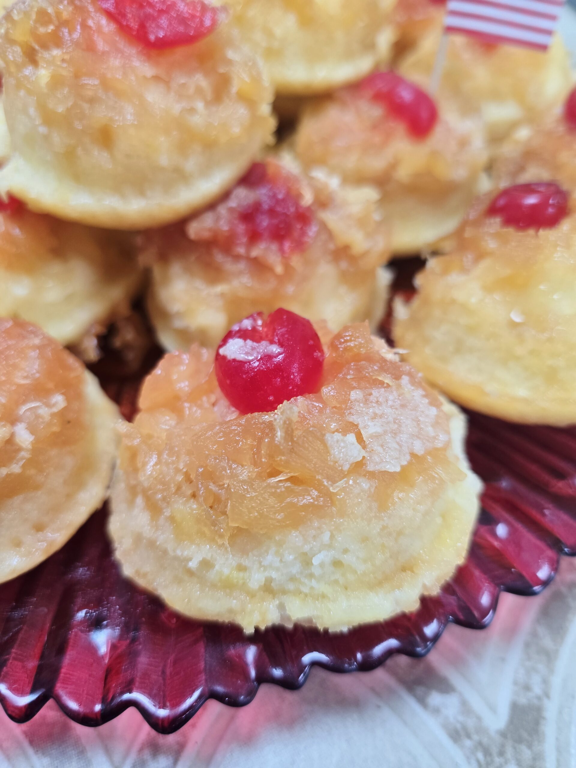 Gluten free pineapple upside down cupcakes served on a dessert plate