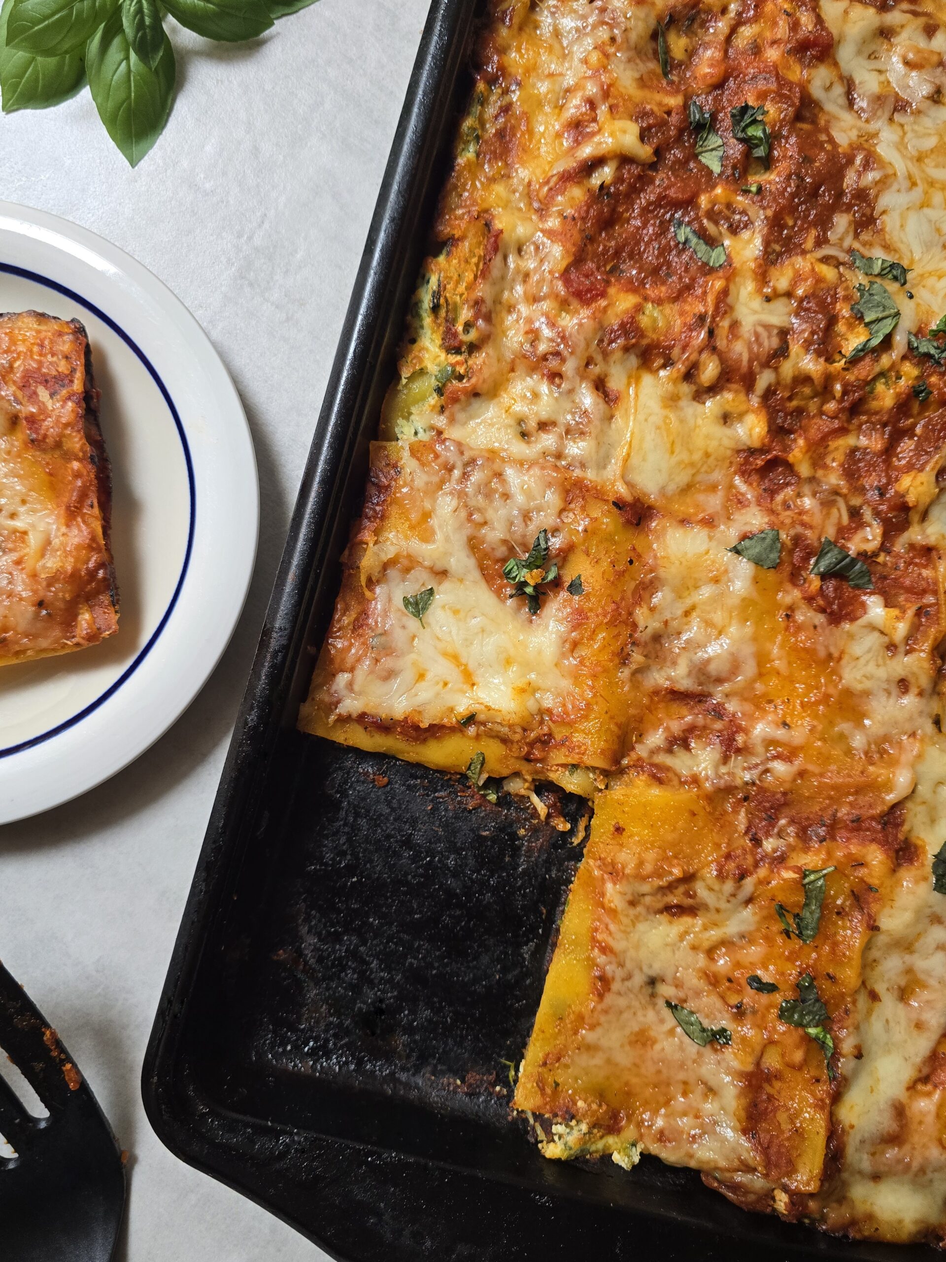 Gluten free sheet pan lasagna with melted mozzarella and crispy golden edges