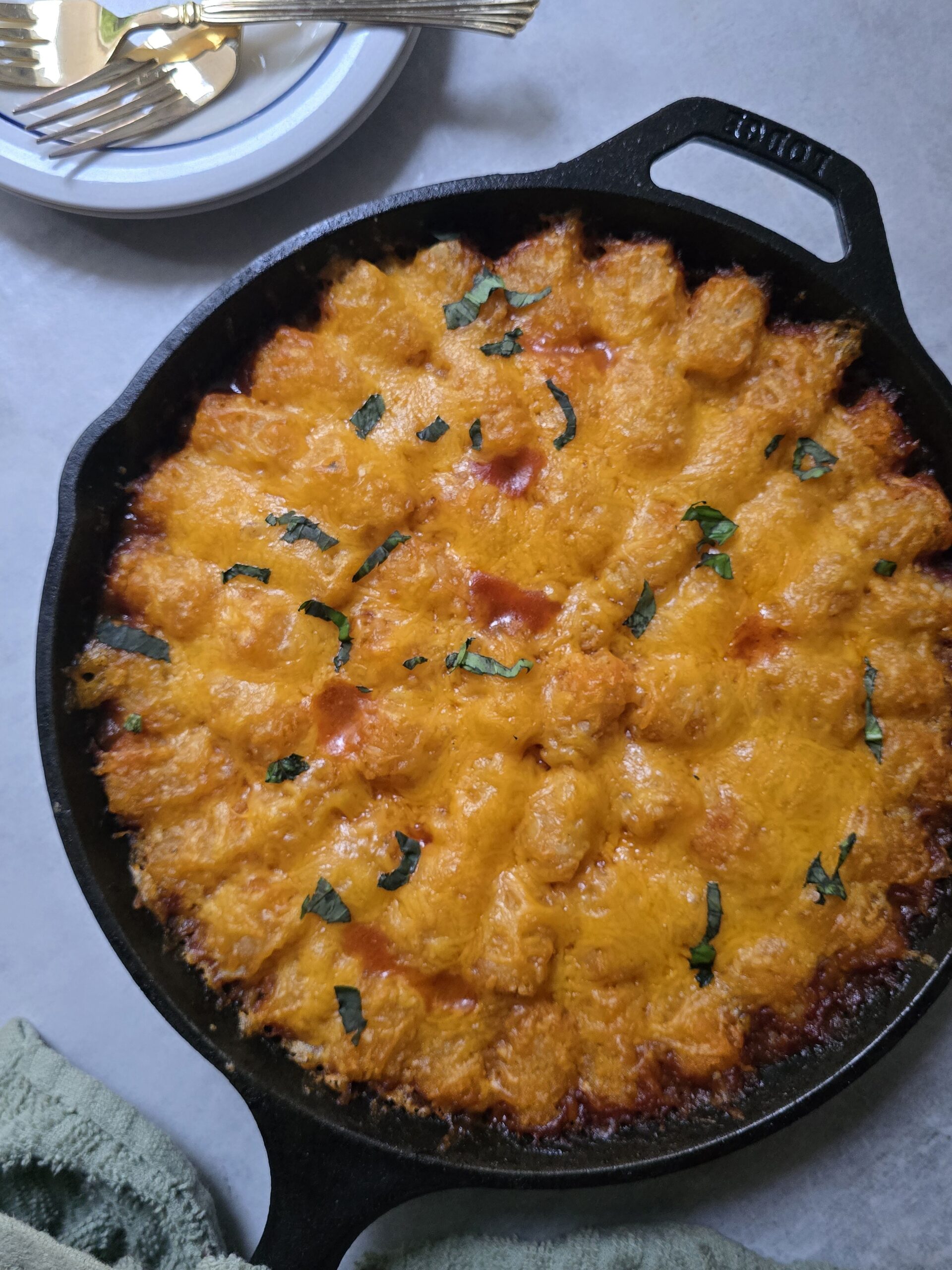 Sloppy Joe tater tot casserole in a baking dish with crispy golden tater tots